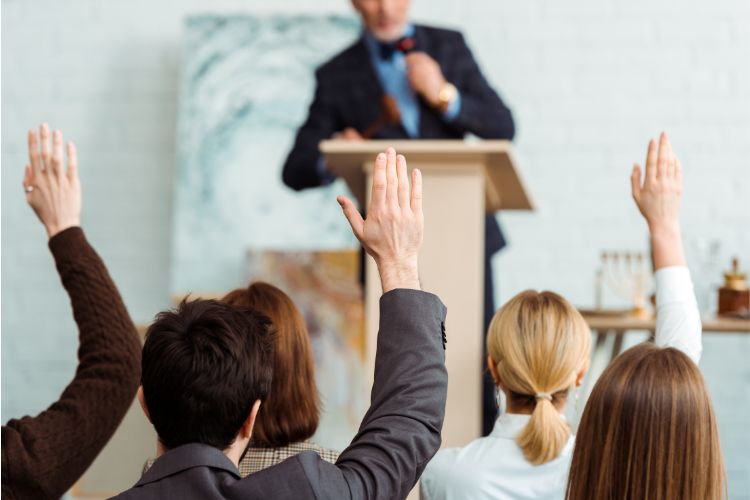 A businessman giving a presentation to a group of people.