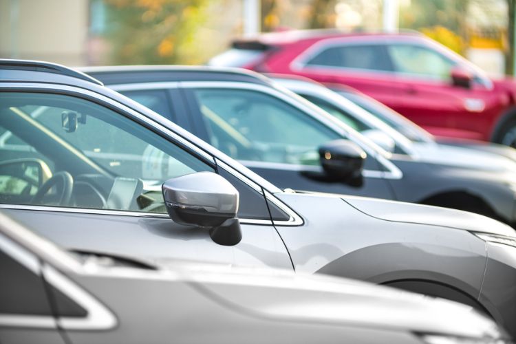 A row of cars parked in a parking lot.