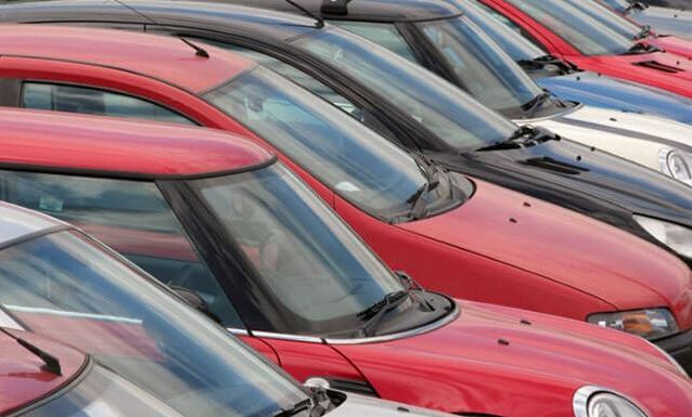 A row of cars parked in a parking lot.