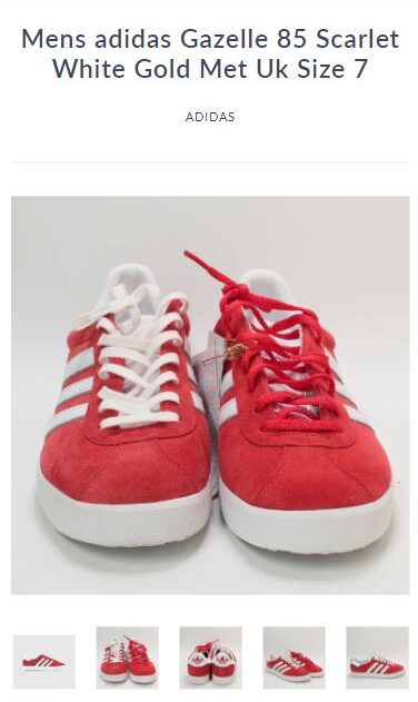 A pair of red and white adidas shoes on a website.