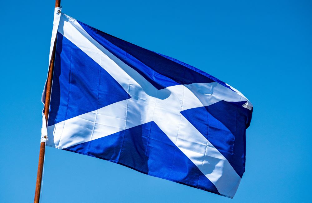 A scottish flag flying in the wind.