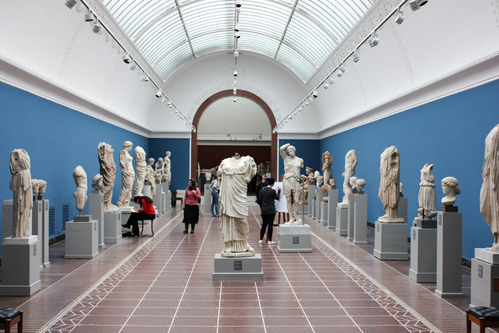 A room full of statues in a museum.