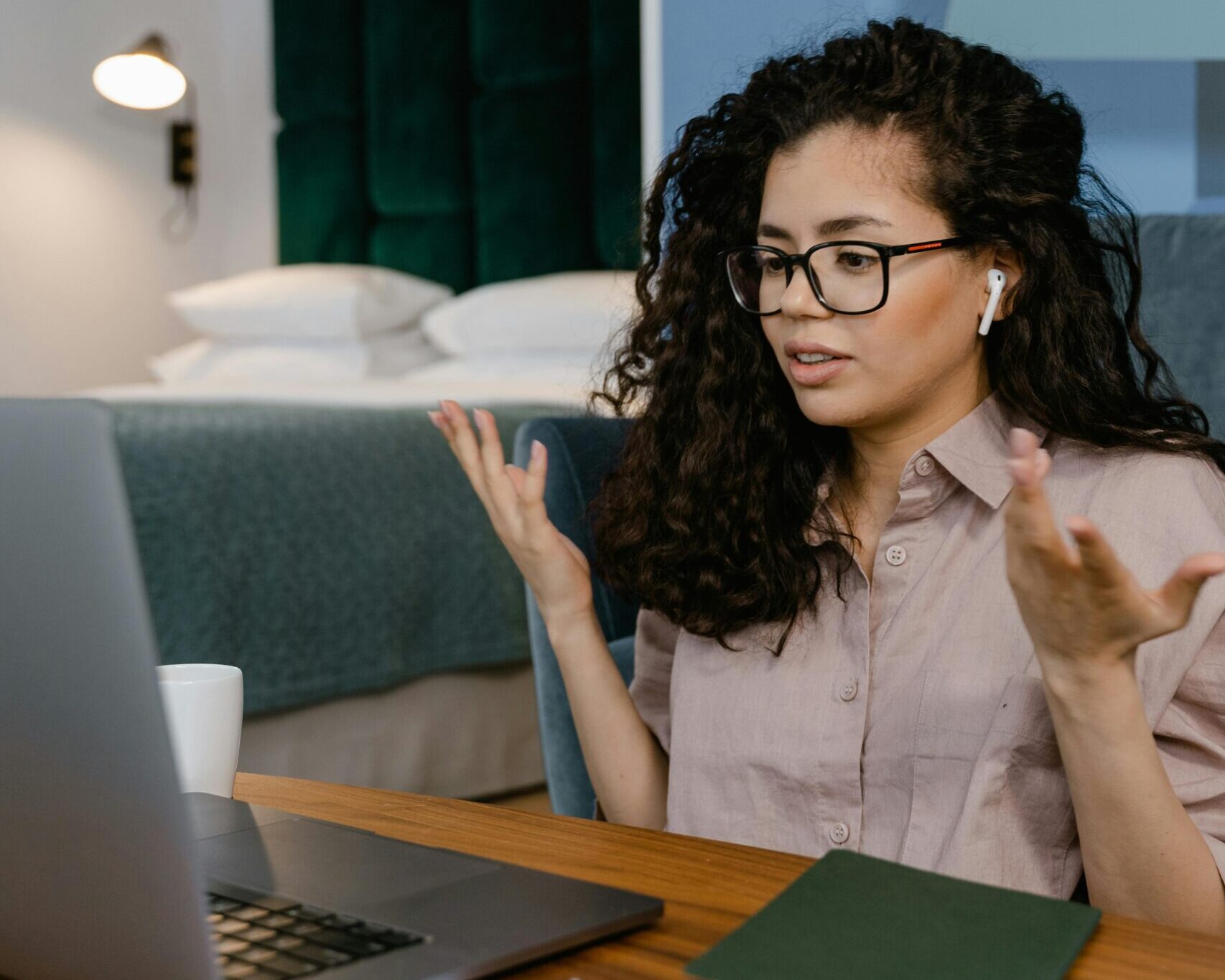 A woman sitting at a desk with a laptop, engaged in paid focus groups to earn extra money.