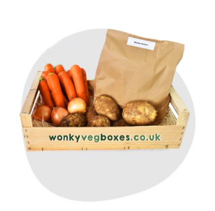 basic box A wooden box labeled "wonky vegboxes.co.uk" contains carrots, potatoes, onions, and a brown paper bag.