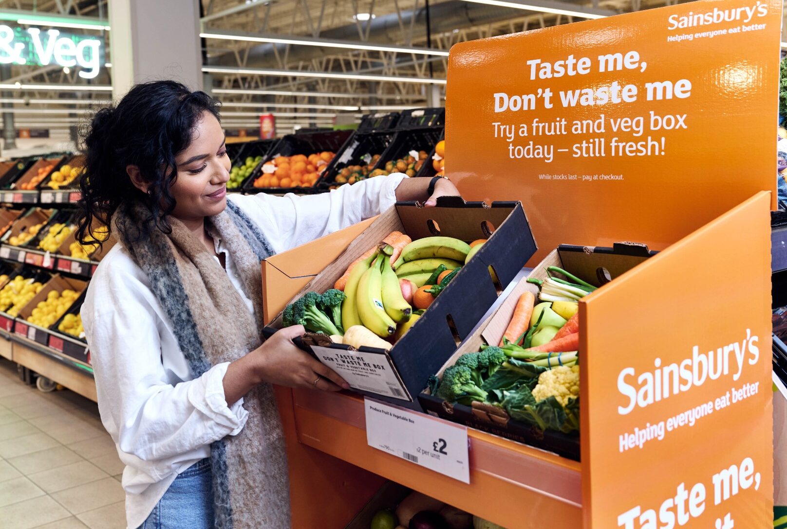 sainsburys taste me dont waste me A person picks up a discounted fruit and vegetable box from a display in sainsburys supermarket.
