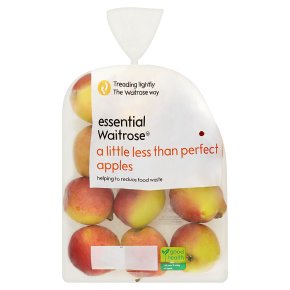 waitrose apples A plastic bag containing several apples labeled "essential Waitrose a little less than perfect apples, helping to reduce food waste." The bag is partially transparent, showing the apples inside.