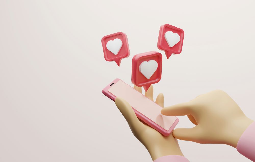 Start cashing in with money-making apps today 3D illustration of a hand using a smartphone with three floating heart icons above the device, representing social media likes or engagement.