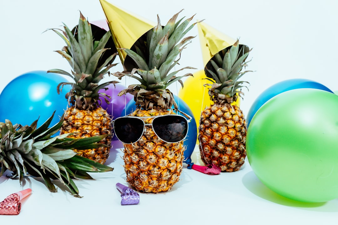 Photo by Pineapple Supply Co. several pineapples at a party