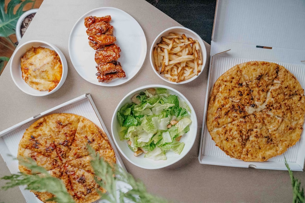 Takeaway pizza An image showing a cheap takeaway pizza meal alongside meat and salad sides