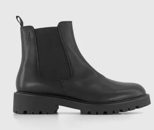 A black leather Chelsea boot with a thick lug sole and elastic side panel, shown in profile against a plain light background.