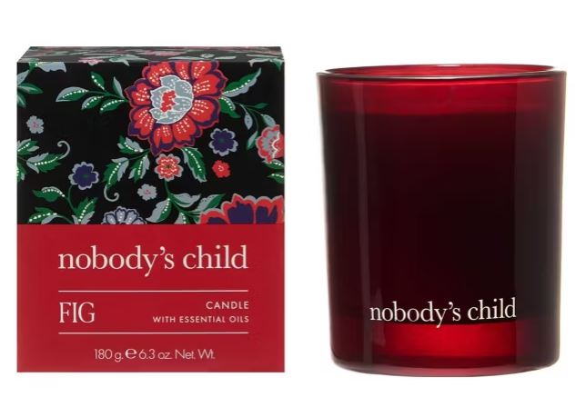 A red candle labeled "nobody's child" sits next to its floral-patterned box, which reads "FIG Candle with essential oils, 180g, 6.3 oz Net Wt.