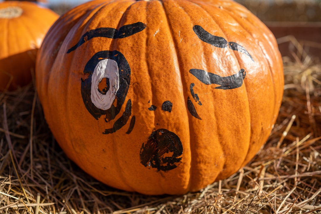 Photo by Gonzalo Sanchez a carved pumpkin with a face