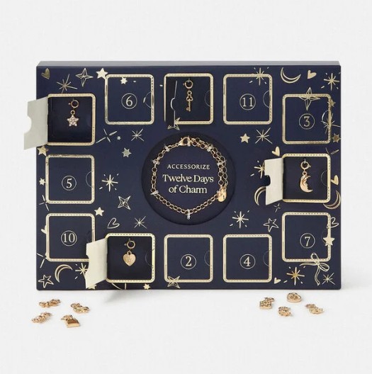 Accessorize 12 Days of Charm Christmas Advent Calendar A navy blue advent calendar labeled "Twelve Days of Charm" with numbered compartments, revealing gold charms and a bracelet inside.