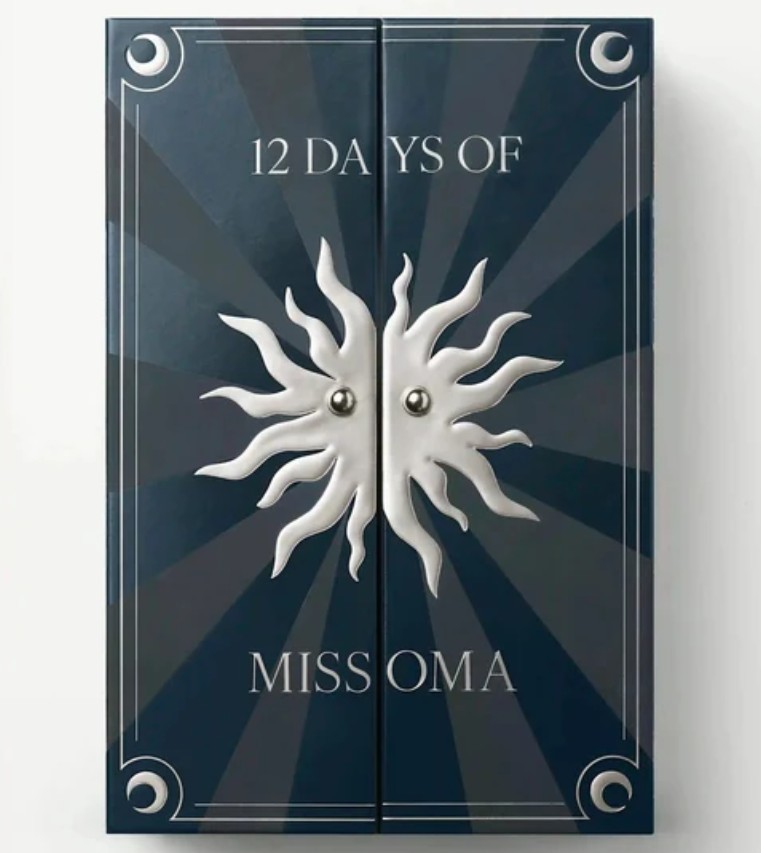 Missoma Silver Advent Calendar 2025 A dark blue box with a sunburst design, labeled "12 Days of Missoma," featuring silver accents and two central metallic knobs.