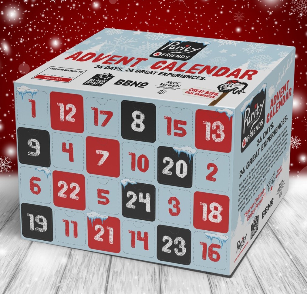 A box labeled "Advent Calendar" with numbered doors from 1 to 24, sitting on a wooden surface with a red, snowy background.