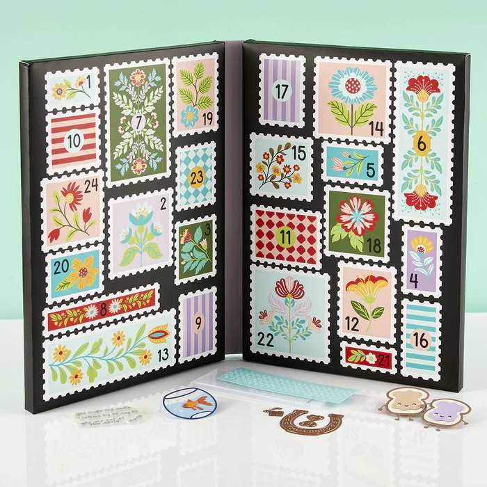 Spellbinders Crafty advent calendar An image showing an open Spellbinders Crafty stationery advent calendar with 24 doors and presents