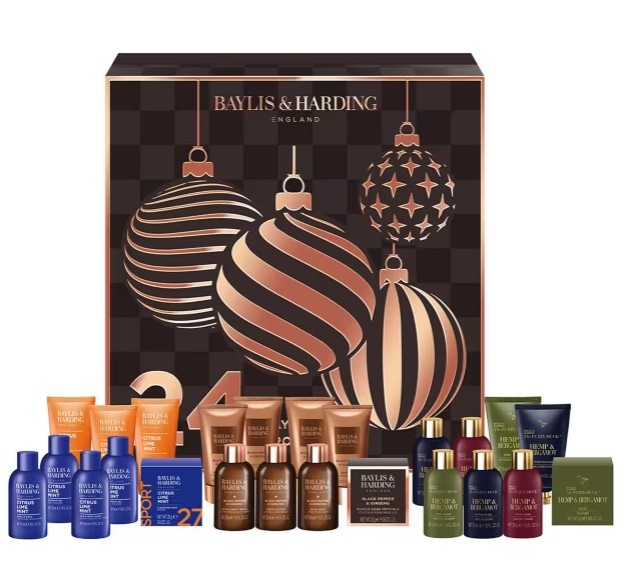 A Baylis & Harding advent calendar box with festive ornament designs displayed behind an assortment of skincare and toiletry products in assorted bottles and tubes.