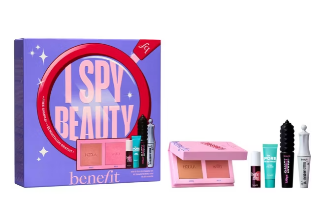 A Benefit Cosmetics “I Spy Beauty” gift set featuring a boxed collection of makeup products, including blush, mascara, primer, and brow gel, displayed against a white background.