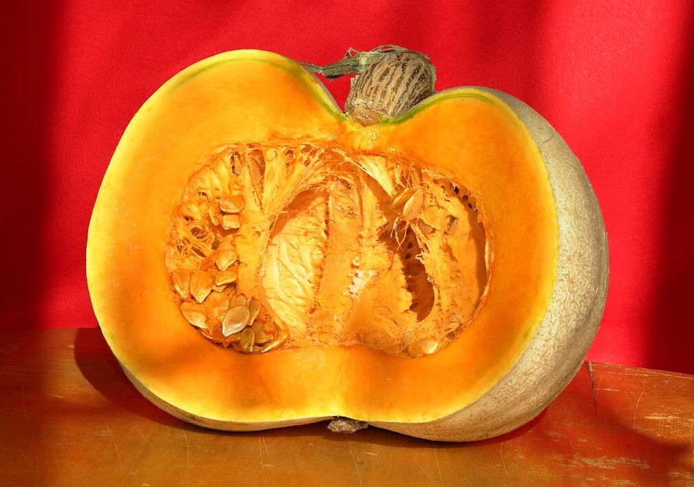 Photo by Mustafa akın A pumpkin cut in half sitting on a table