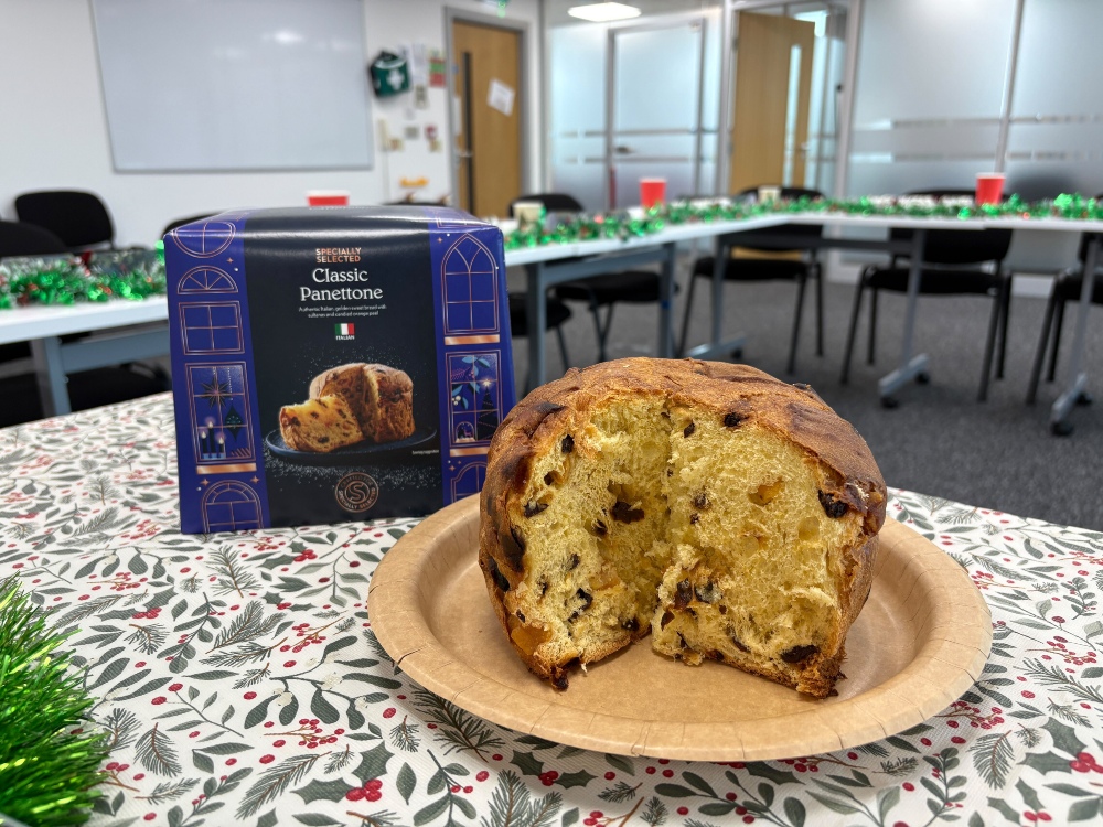 An image showing a sliced Aldi panettone in front of its box