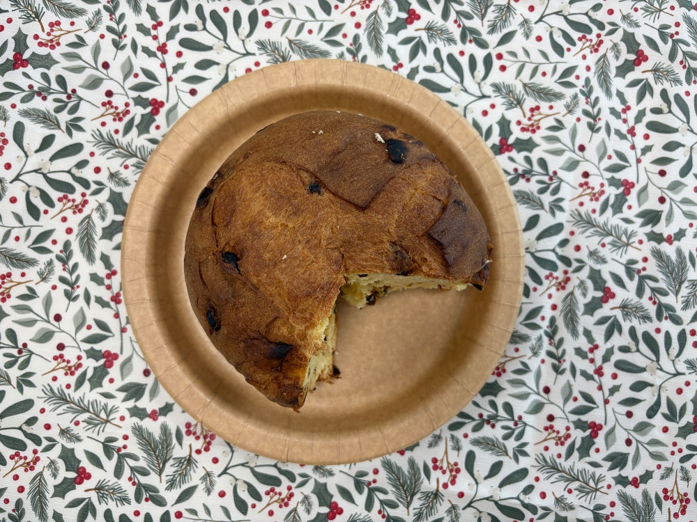 A top-down image of an Aldi panettone, sliced and on a brown plate