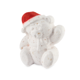 A white bear-shaped bath bomb wearing a red Santa hat sits upright against a plain white background.
