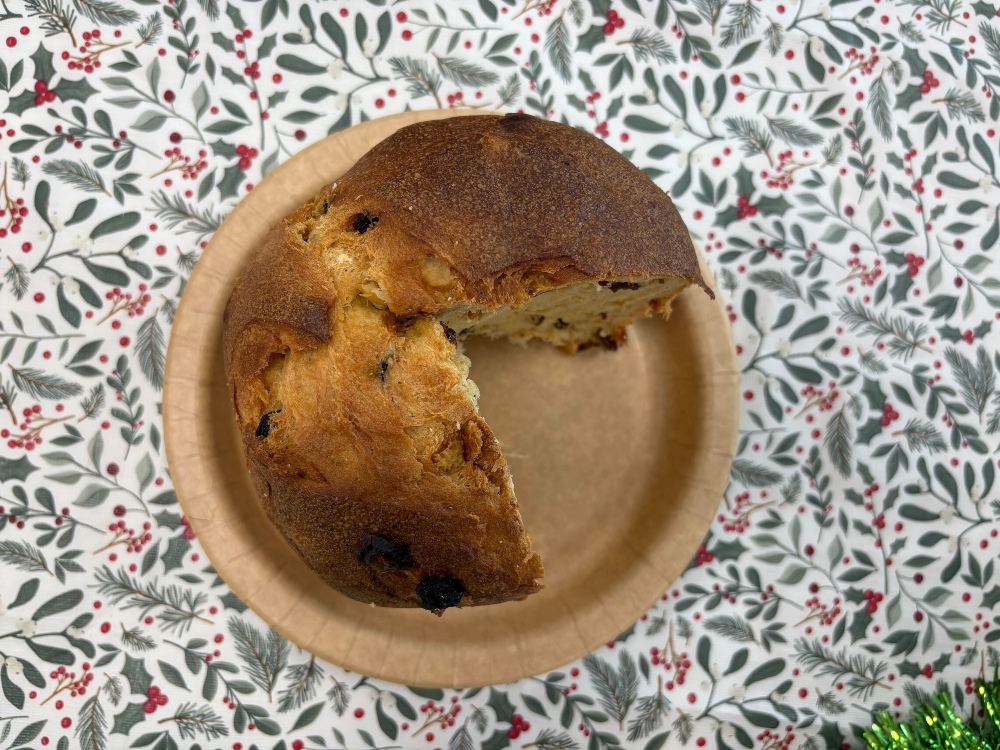 A tall Lidl Panettone with a quarter sliced out of it, shown from the top-down