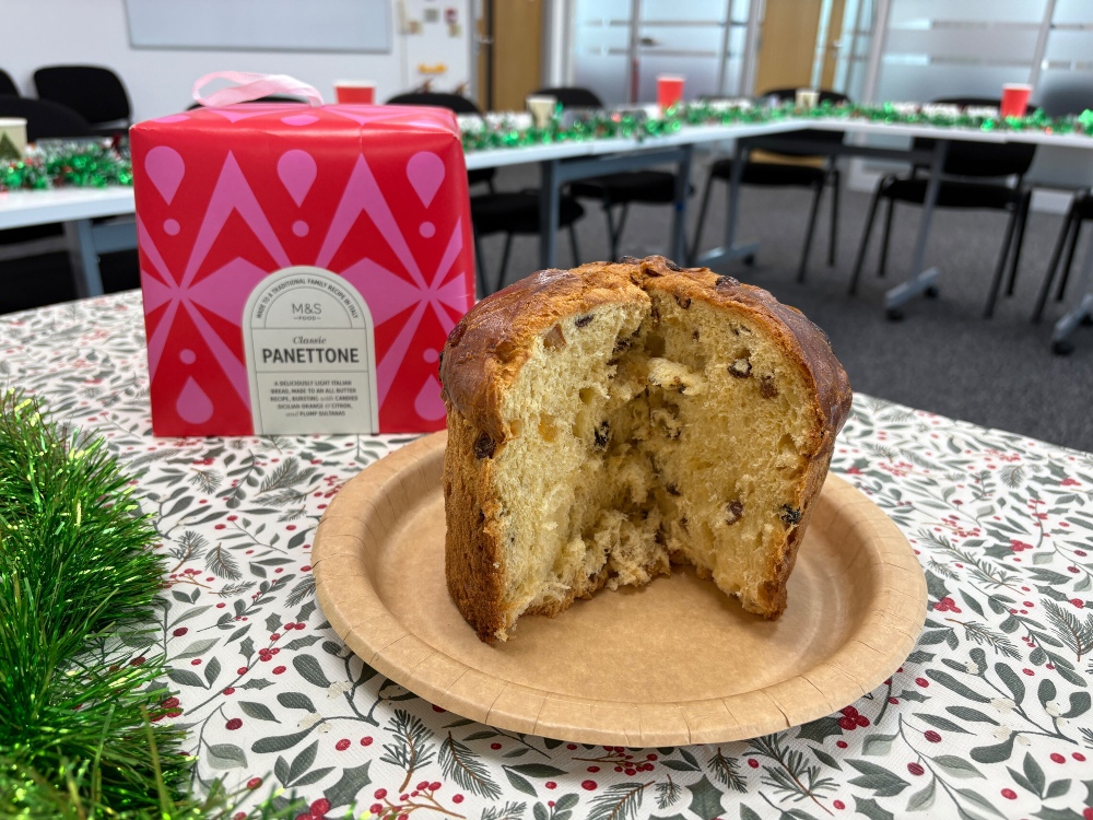 An M&S panettone from the supermarket sitting in front of its box