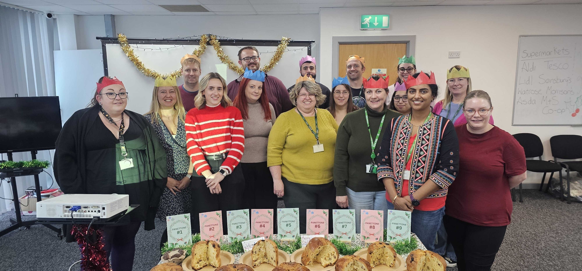An image showing a group of TopCashback employees performing a Christmas taste test for the best panettone