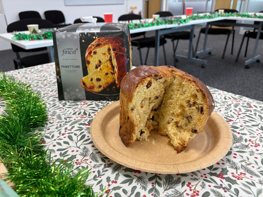 An image showing a Tesco panettone with its box, slightly lopsided after slicing