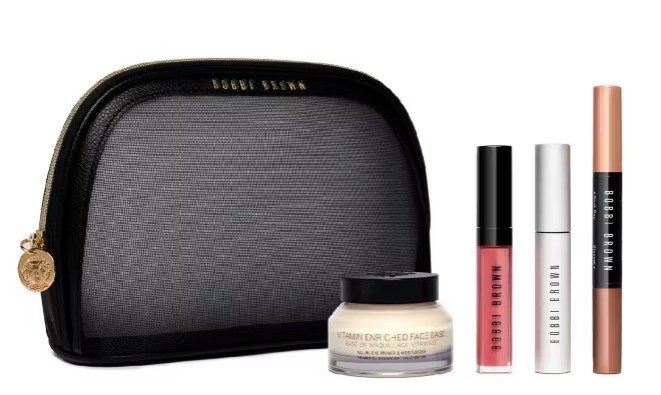 A black mesh Bobbi Brown makeup bag with a gold zipper, displayed with face base cream, lip gloss, mascara, and two makeup pencils in various shades.