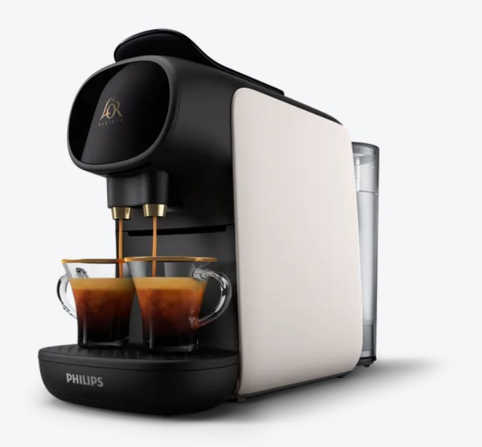 A Philips L'OR coffee machine brews two cups of espresso, dispensing coffee into two clear glass cups placed on the drip tray.