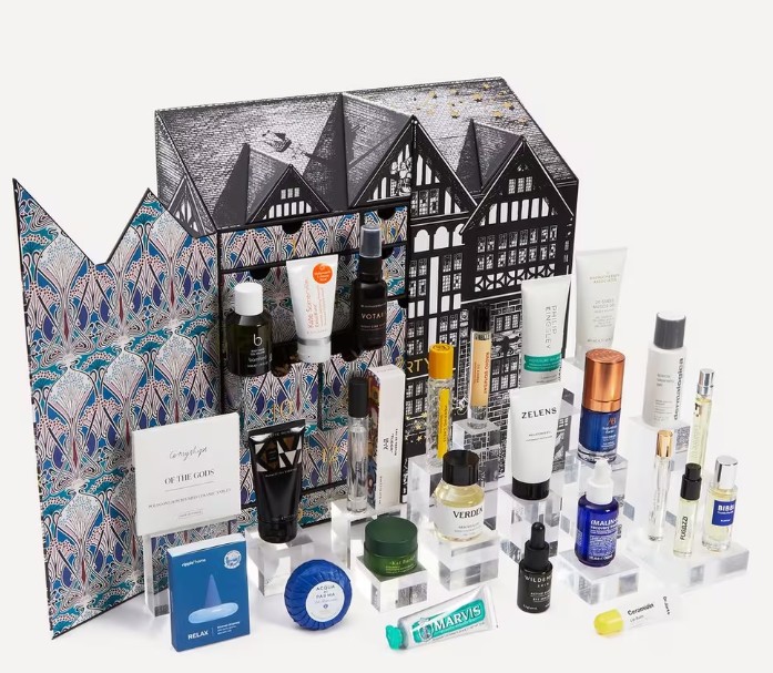 A collection of skincare and beauty products displayed in front of an illustrated box with a black and white building design.