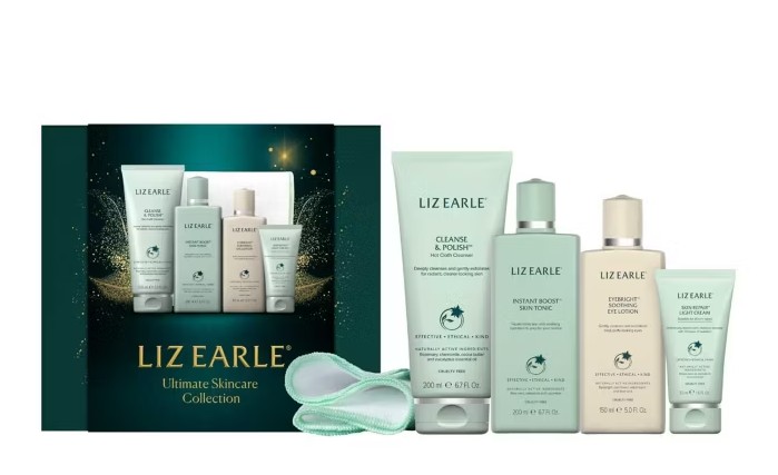 A Liz Earle Ultimate Skincare Collection box next to four skincare products and two cleansing cloths, all labeled with the Liz Earle brand.