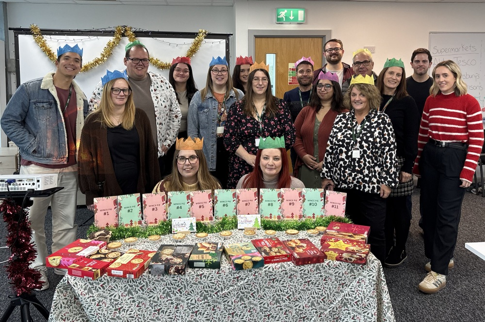 An image showing festive TopCashback employees during a supermarket mince pie taste test