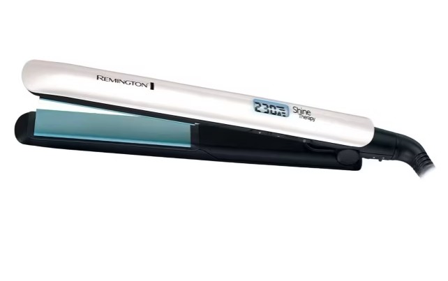 A Remington Shine Therapy hair straightener with a digital temperature display and ceramic plates, shown open and angled to the side.