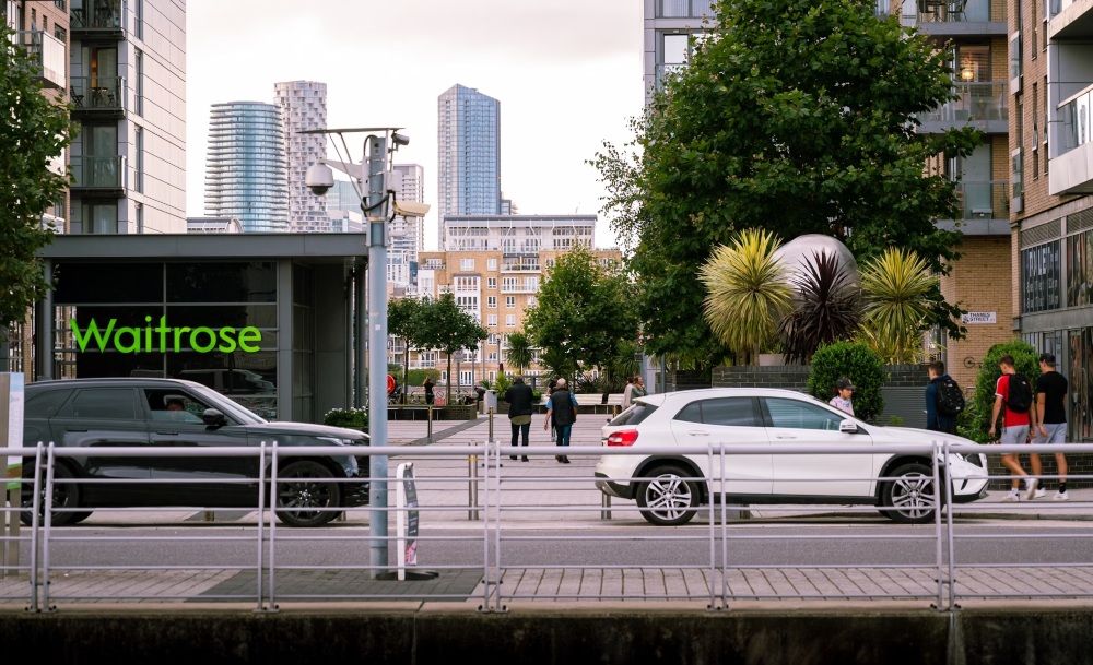 waitrose supermarket An image showing a Waitrose supermarket with vehicles in front of it