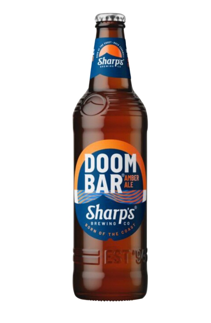 doom bar amber ale A brown glass bottle of Sharp’s Doom Bar Amber Ale with a blue and orange label, shown on a white background.