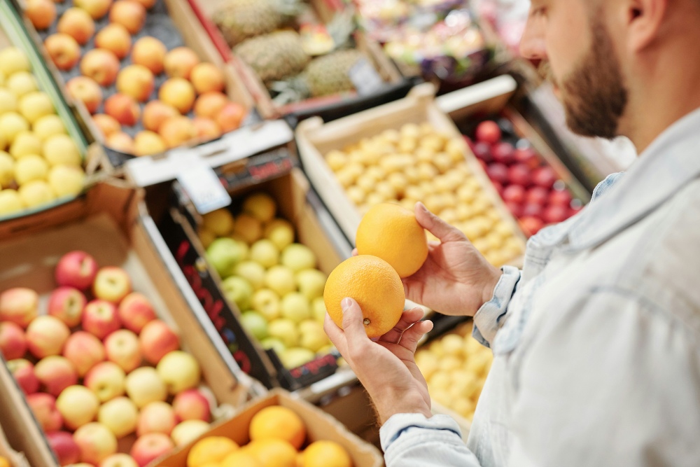 A person buying fruit in a grocery store