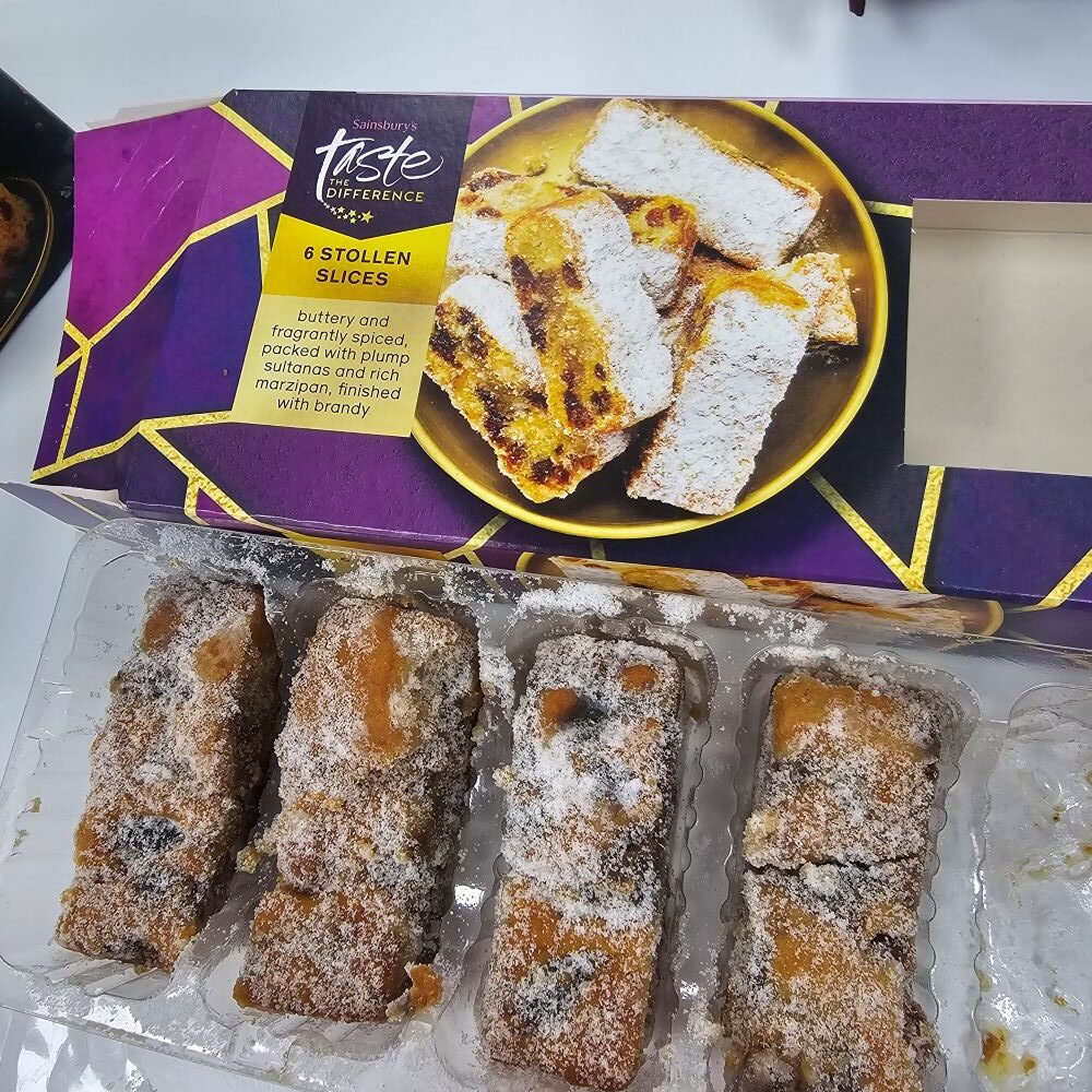 tcb sainsburys taste the difference stollen slices An open box of Sainsbury's Taste the Difference Stollen Slices, showing sugar-dusted fruit cake slices with marzipan inside a plastic tray.