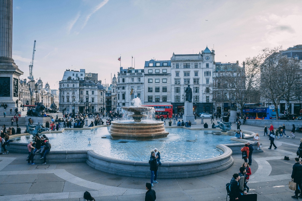 An image showing a free Trafalgar Square fountain in London, and other buildings