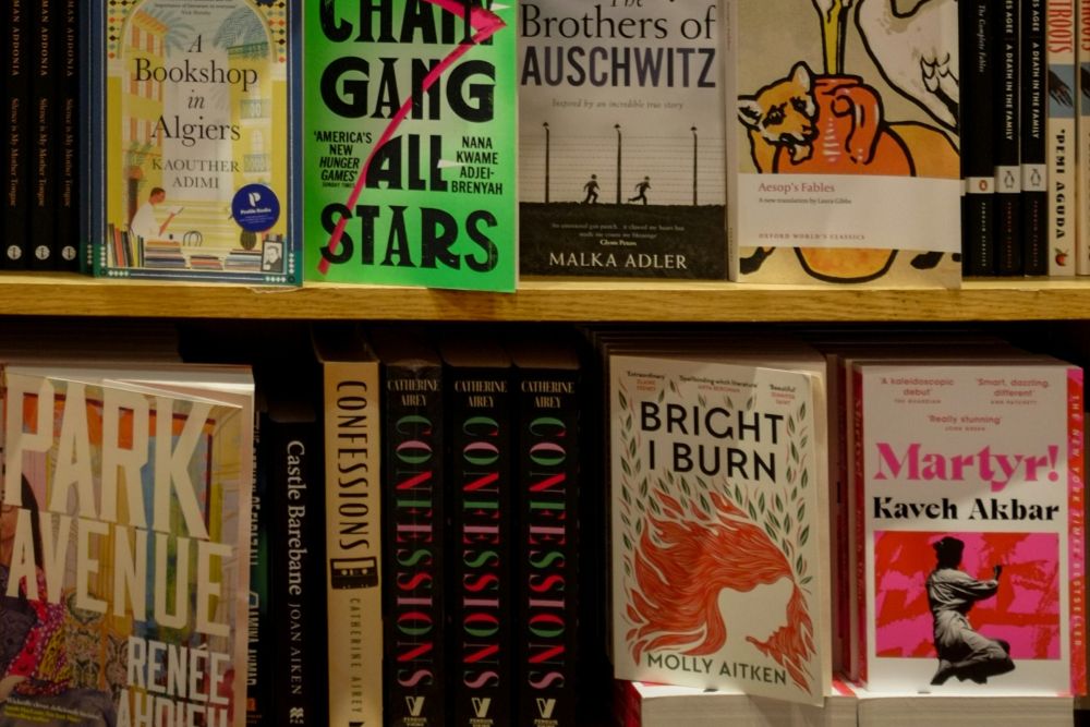 Best site for second hand books UK. A bookshelf displays various books with visible covers.
