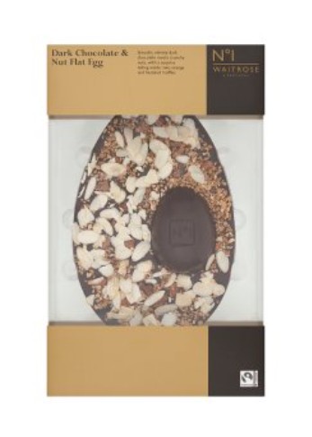 A boxed Waitrose No.1 dark chocolate and nut flat egg, topped with assorted nuts and seeds, shown in its original packaging.