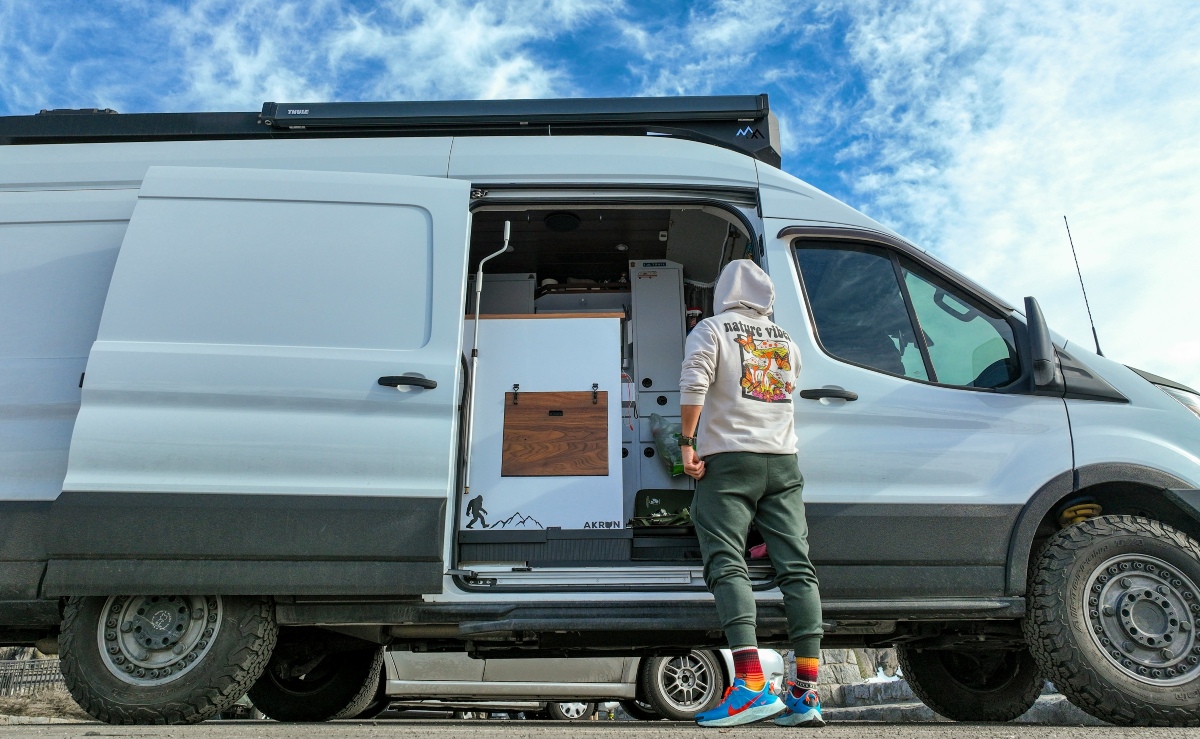 Storage auctions van A person loading items bought at a storage auction into a white van