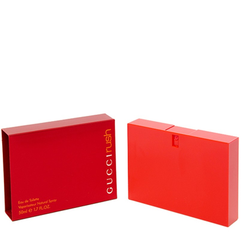 A red rectangular Gucci Rush perfume box is shown next to its matching red bottle, both with minimalist designs and gold text.