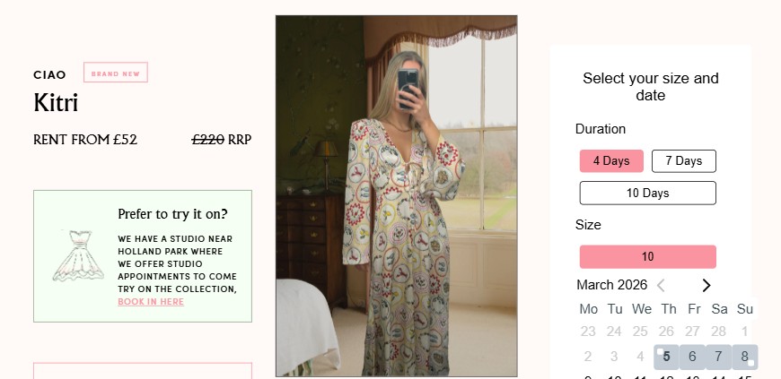 loan the look desktop A person stands in front of a mirror wearing a long, patterned dress, taking a selfie. A window with greenery outside is visible in the background.