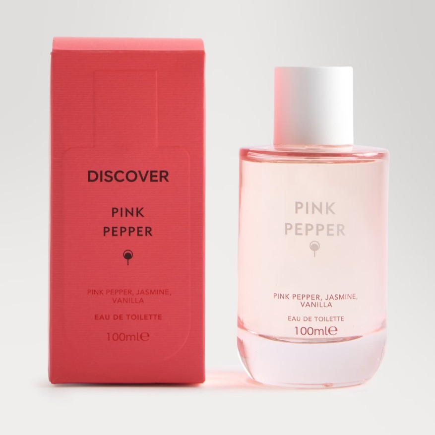 A clear bottle of Pink Pepper eau de toilette with a white cap is shown next to its coral pink box labeled with scent notes: pink pepper, jasmine, and vanilla, 100ml.