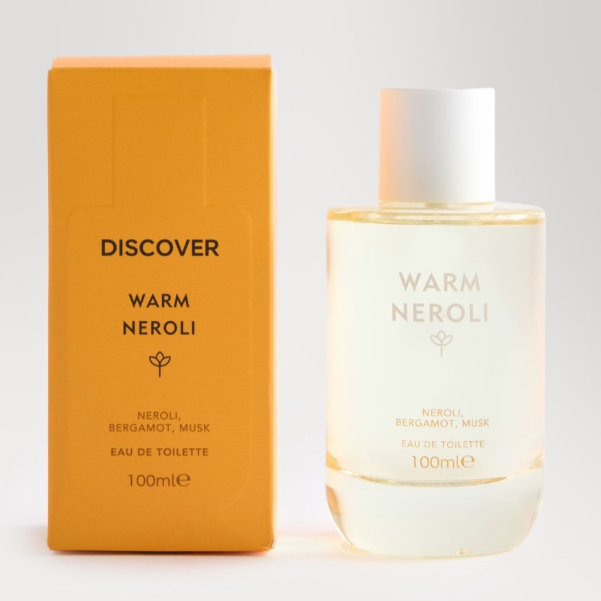 A 100ml bottle of "Warm Neroli" eau de toilette is shown next to its orange packaging, which is labeled with the scent notes: neroli, bergamot, and musk.