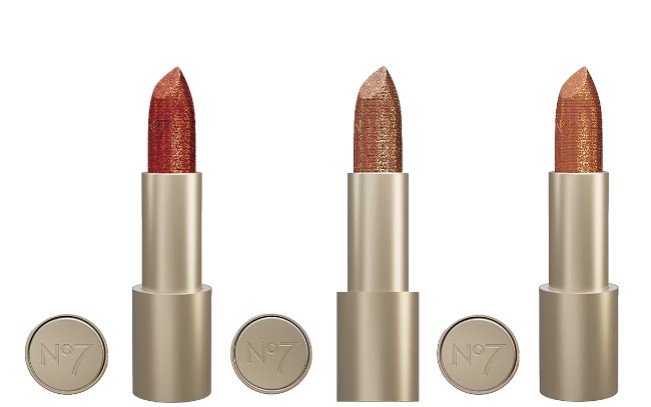 no7 lipstick bundle Three No7 lipsticks with gold tubes and removed caps, in shades of red, bronze, and nude, displayed side by side against a white background.