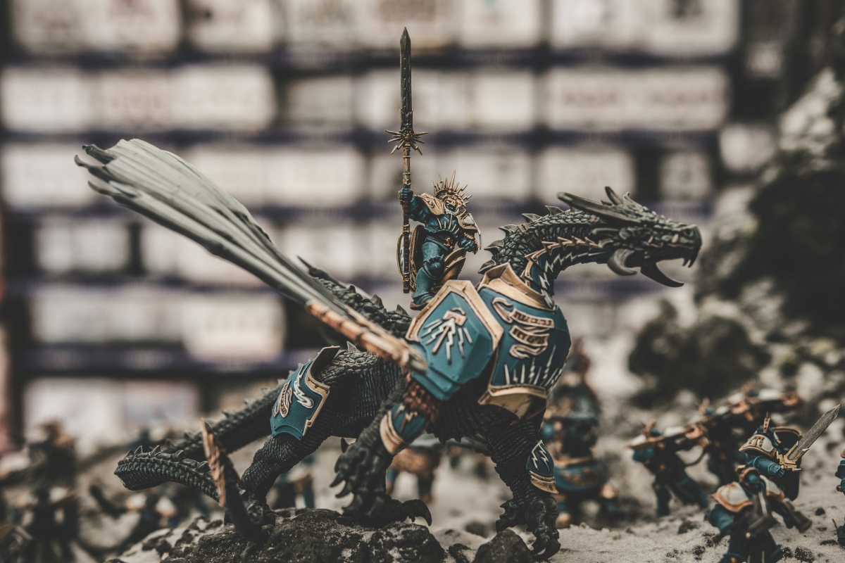 Warhammer dragon A Warhammer miniature in armour on the back of a dragon, wielding a spear